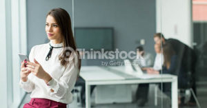 Businesswoman with the phone in the office